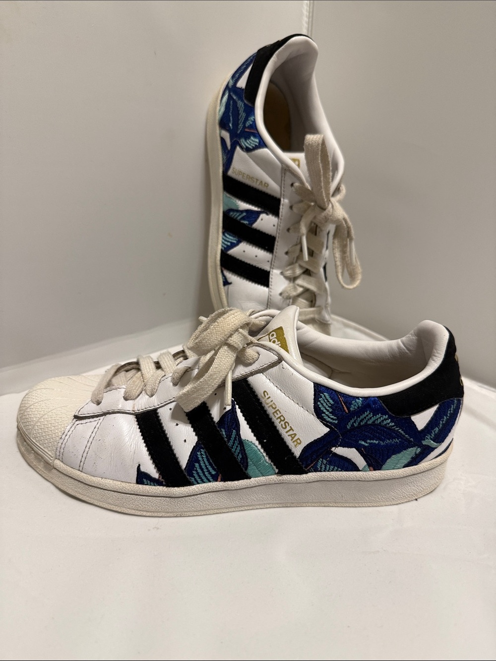 adidas White Sneakers with Black Stripes and Blue Floral Detail